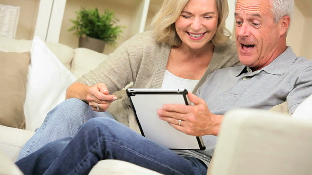 Mature Couple Having Fun with a Wireless Tablet
