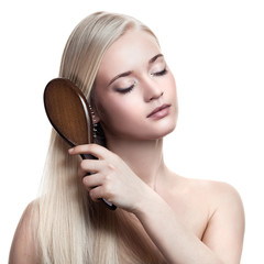 portrait of a beautiful young blonde woman comb wonderful hair