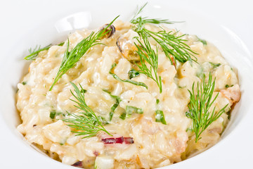 photo of delicious risotto with seafood and dill on it