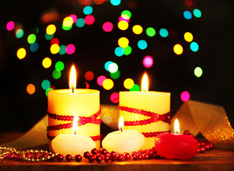 Beautiful candles and decor on wooden table on bright background