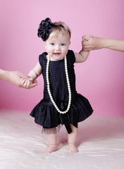 Little girl in black dress in studio