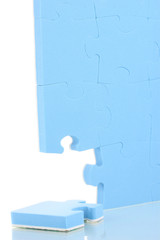 Blue puzzles closeup, isolated on white