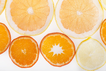 Fresh slices of citrus fruits in studio backlight
