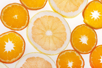 Fresh slices of citrus fruits in studio backlight