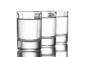 Three glass of vodka isolated on white