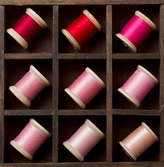 Vintage pink and red spools of thread