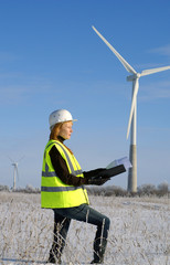 woman engineer against wind turbines
