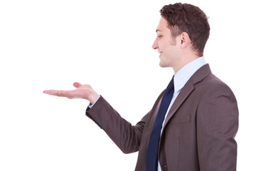 Happy business man showing something