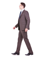 side view of a young businessman walking