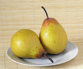 photo of two pears on a white plate