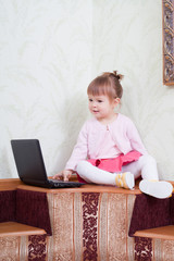 little girl sits on a sofa