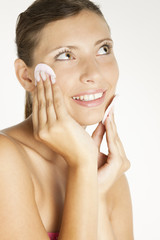 portrait of young woman with cotton pads