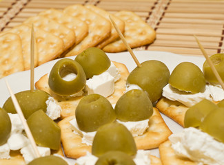 Crackers with olives and cheese feta