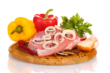 Raw meat and vegetables on a wooden board isolated on whitе
