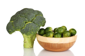 Brussels sprouts in wooden bowl and broccoli isolated on white