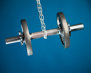 hanging dumbbell, blue background