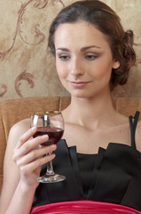 Portrait of a young and beautiful girl with a glass of red wine