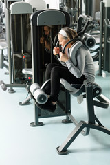 Fototapeta na wymiar Fitness center senior woman exercise abs muscles