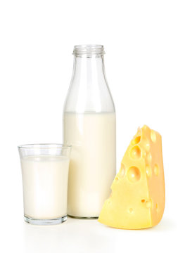Slice of fresh cheese and milk bottle with glass