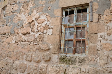 Old square wooden window in stone rendered wall of house