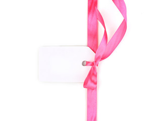 Blank gift tag with pink satin bow and ribbon isolated on white