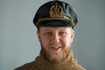 Smiling, bearded captain