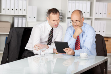 zwei geschäftsleute arbeiten mit tablet-computer