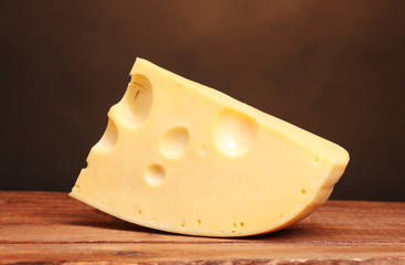 Сheese on wooden board in the room