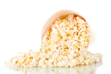Full bucket of popcorn dropped isolated on white