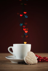 cup of coffee on wooden table on bright bokeh backdground