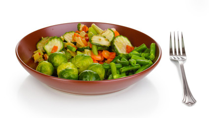 Mixed vegetables on plate isolated on white