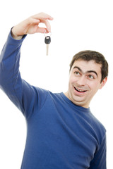 Young man holding keys in his hand, white background