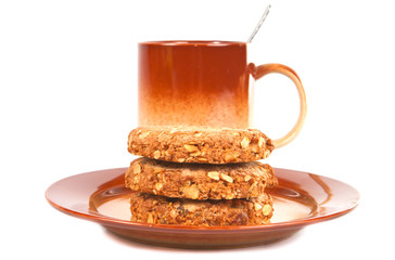 Oatmeal cookies on brown plate.