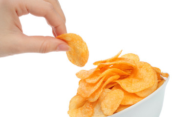 Hand holds a potato chip with the bowl of potato chips