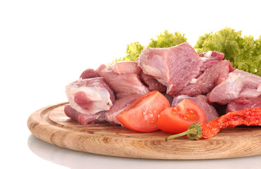 Pieces of raw meat and vegetables