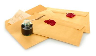 feather, ink and old letters isolated on white.