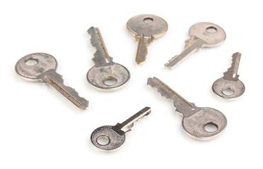 Many metal keys isolated on white