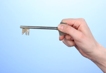 Key in hand on blue background