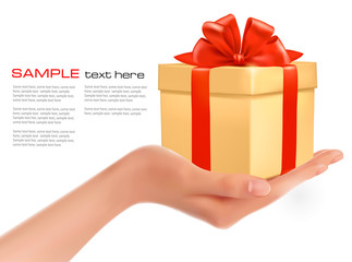 Gift box in hand with red bow and ribbons. Vector.