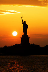 Statue of Liberty silhouette at sunset
