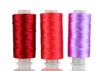 Three bobbin thread isolated on white
