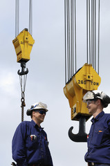 giant crane hooks and engineers
