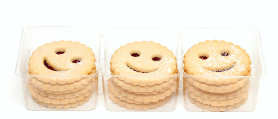 smiling cookies in plastic box isolated on white