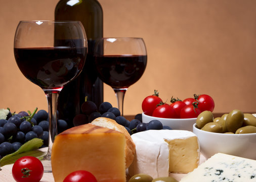 Still life with cherry tomato, red wine and cheese
