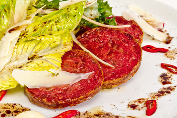 Salad from fried sausages, lettuce with sour cream sauce