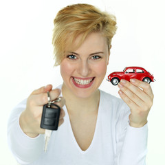 Young woman is proud to have a new red car