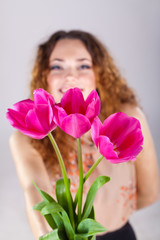 beautiful woman with flowers in studio