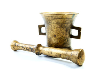 Brass mortar with a pestle isolated on a white