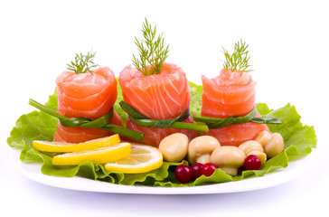 Tasty salmon rolls with mushroom, lemon and salad on the plate