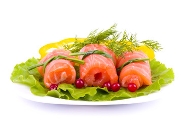 Tasty salmon rolls with green salad on the plate